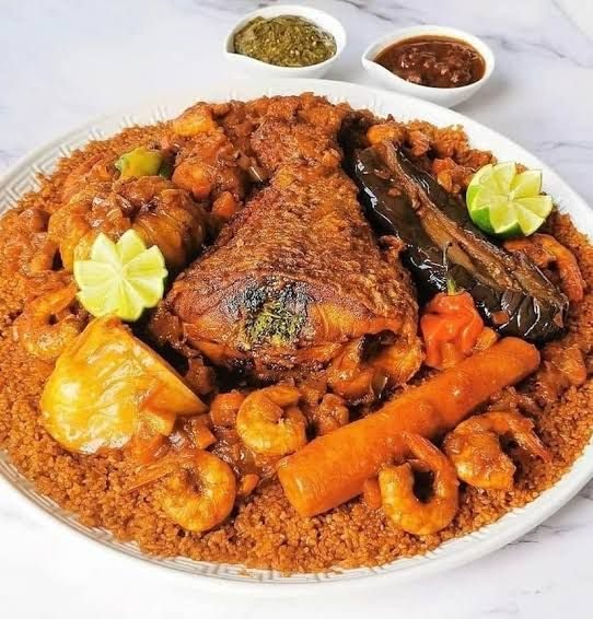 A plate of thiéboudienne with fish, vegetables and prawns